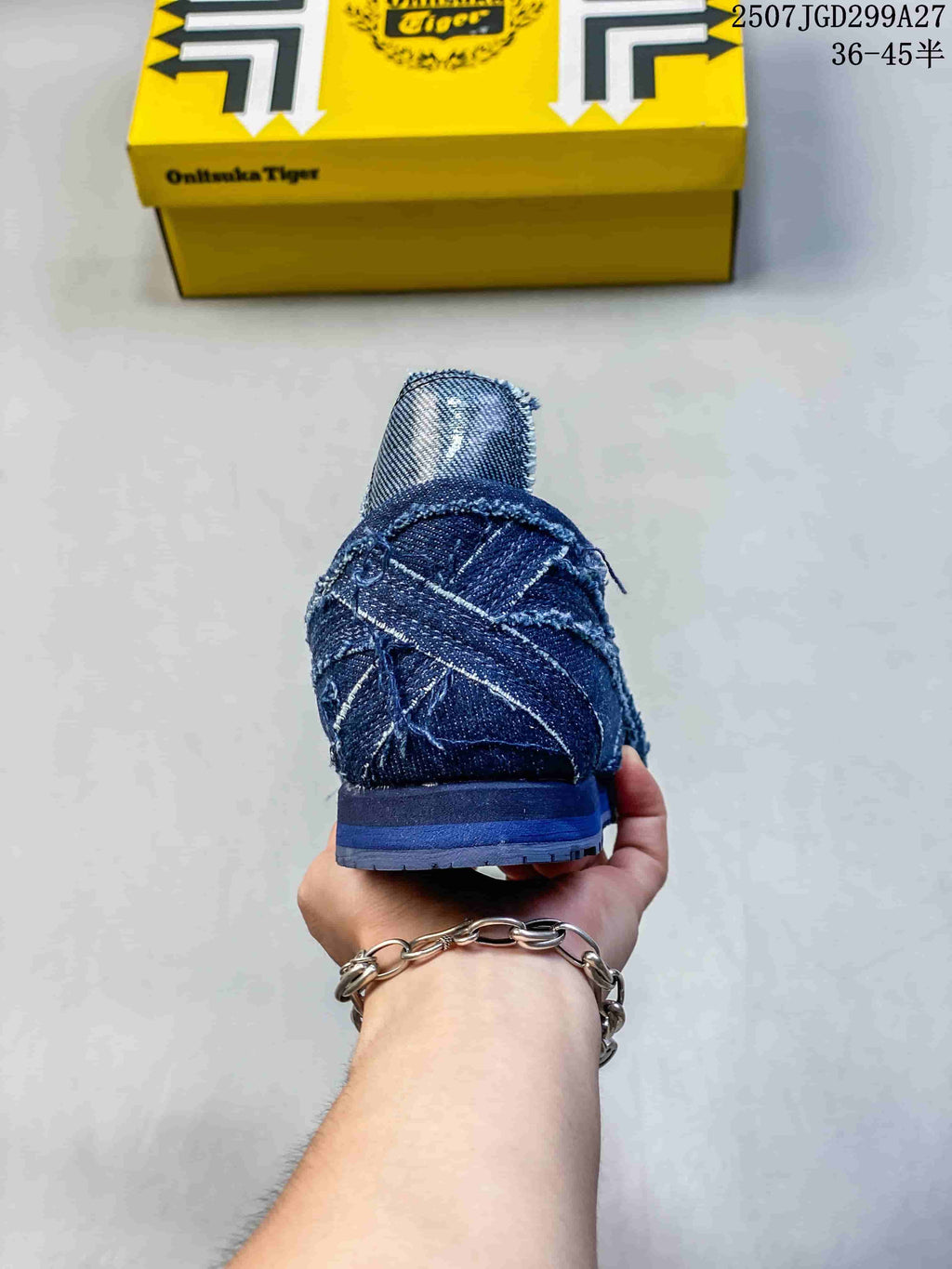 Rear view of a blue sneaker showing the heel construction, contrast stitching and outsole.