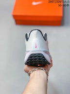 Rear view showing the white heel, black collar lining and pink Nike logo.