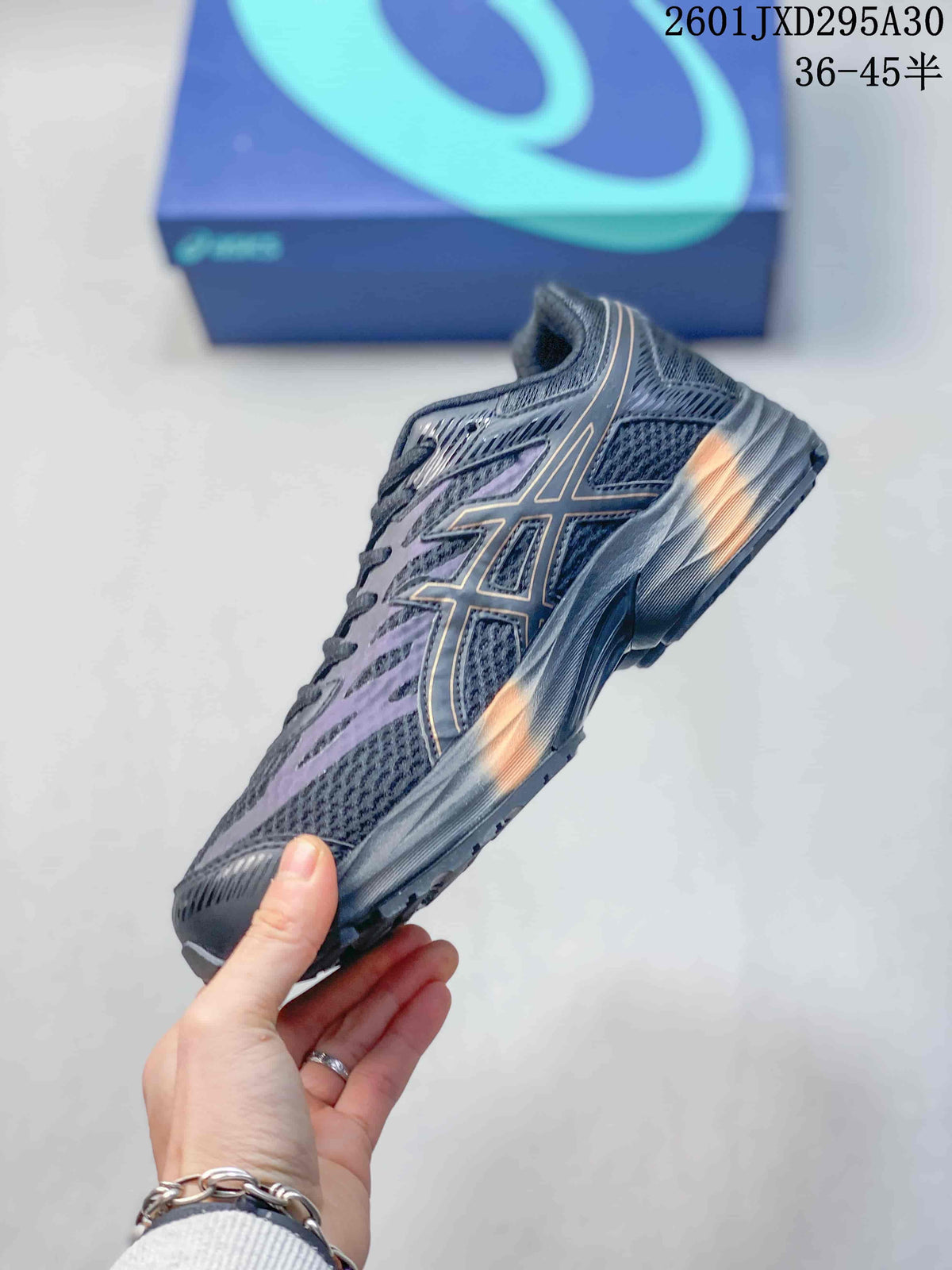 Side view of a charcoal ASICS GEL-KAHANA 8 shoe with orange accents; image text gives a 36–45.5 size range.