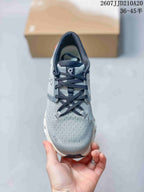 Top view showing the gray textured upper, black laces, and perforated toe area.