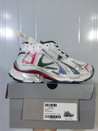 Side view of the Puma 9934 sneaker displayed on its shoebox, showing the layered upper and multicolor outsole.