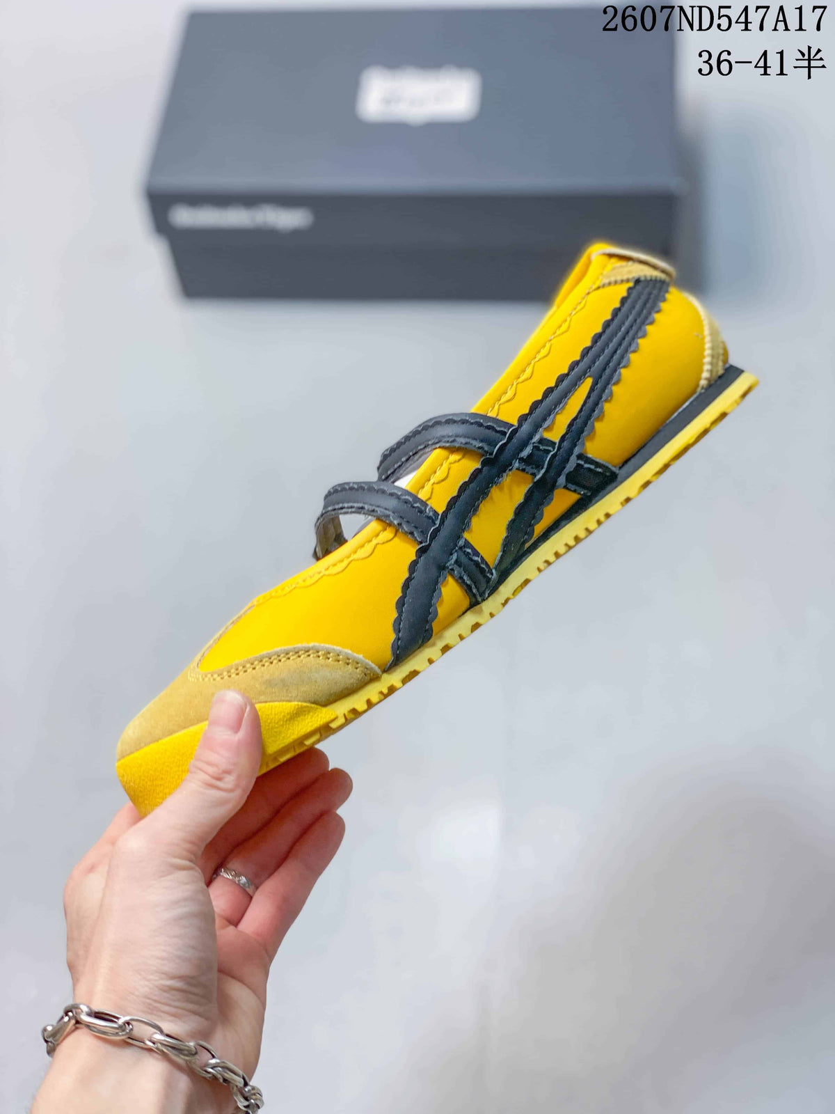 Side profile showing the low silhouette, black double straps, buckle closures and yellow outsole.
