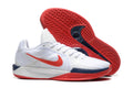 Nike Sabrina 1 basketball shoe pair showing white uppers, red Swoosh branding, navy accents, and red patterned outsole