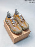 Pair of NORDA 001 G+ sneakers in mustard, beige, gray, and white displayed on a branded shoebox; style code and size range are overlaid.