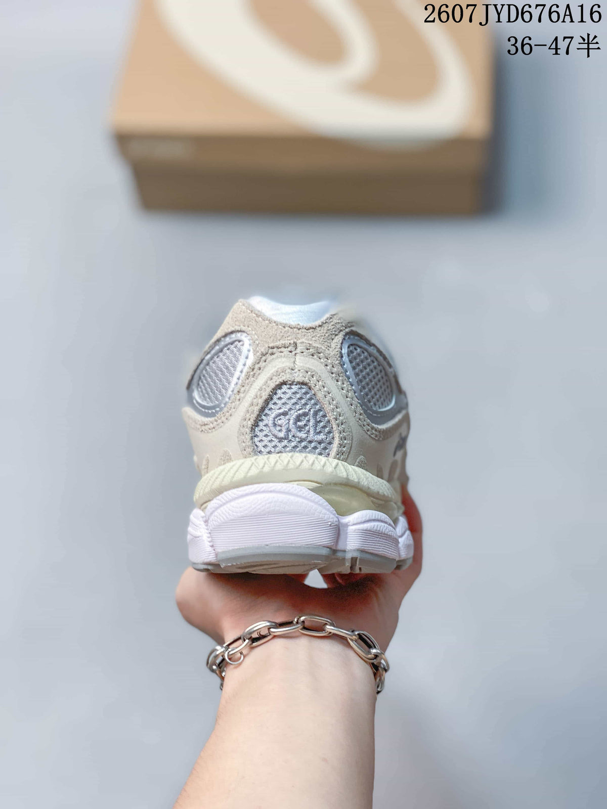 Rear view of the sneaker showing the layered heel construction, mesh panels, and padded collar.