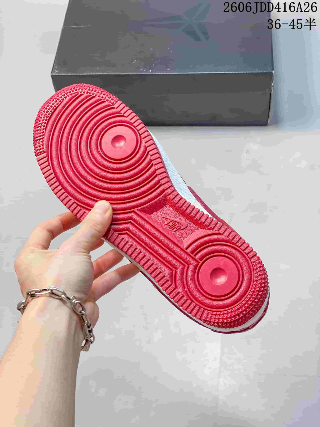 Red outsole of a patterned low-top sneaker