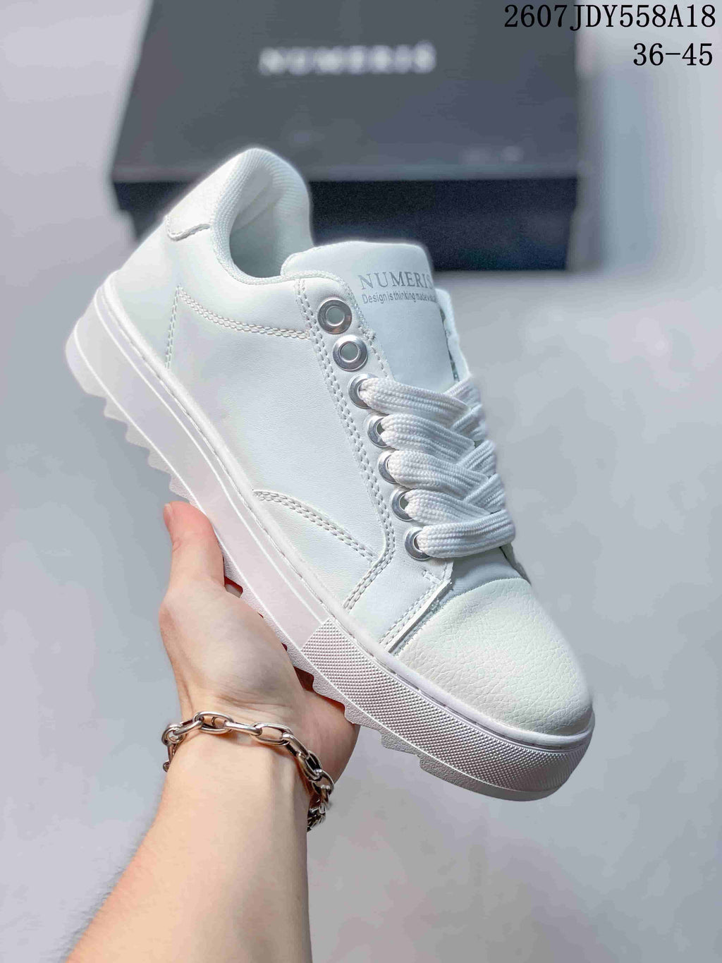 All-white NUMERIS low-top sneaker with white laces, matching toe cap and raised sole; image shows size range 36-45.