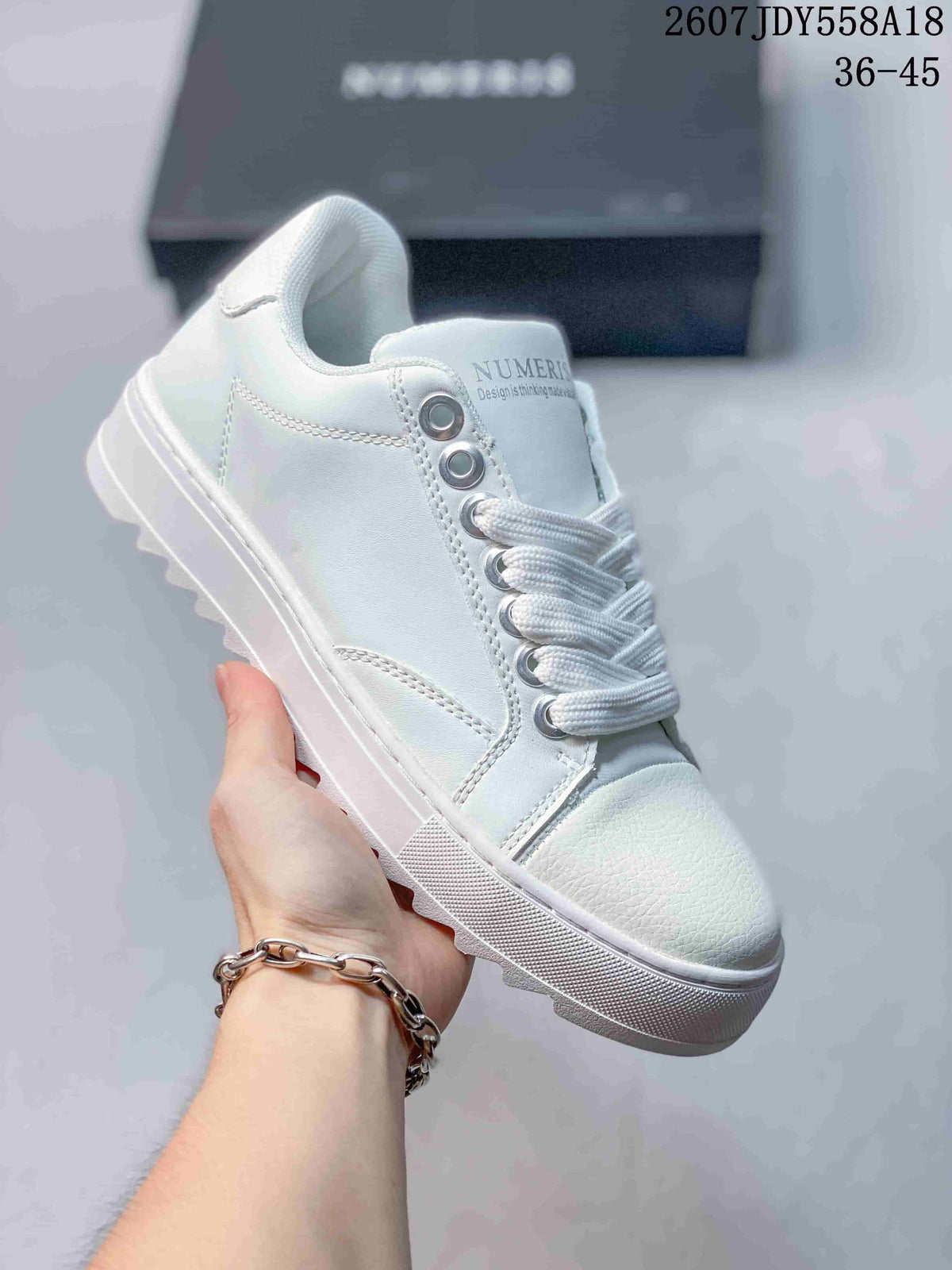 All-white NUMERIS low-top sneaker with white laces, matching toe cap and raised sole; image shows size range 36-45.