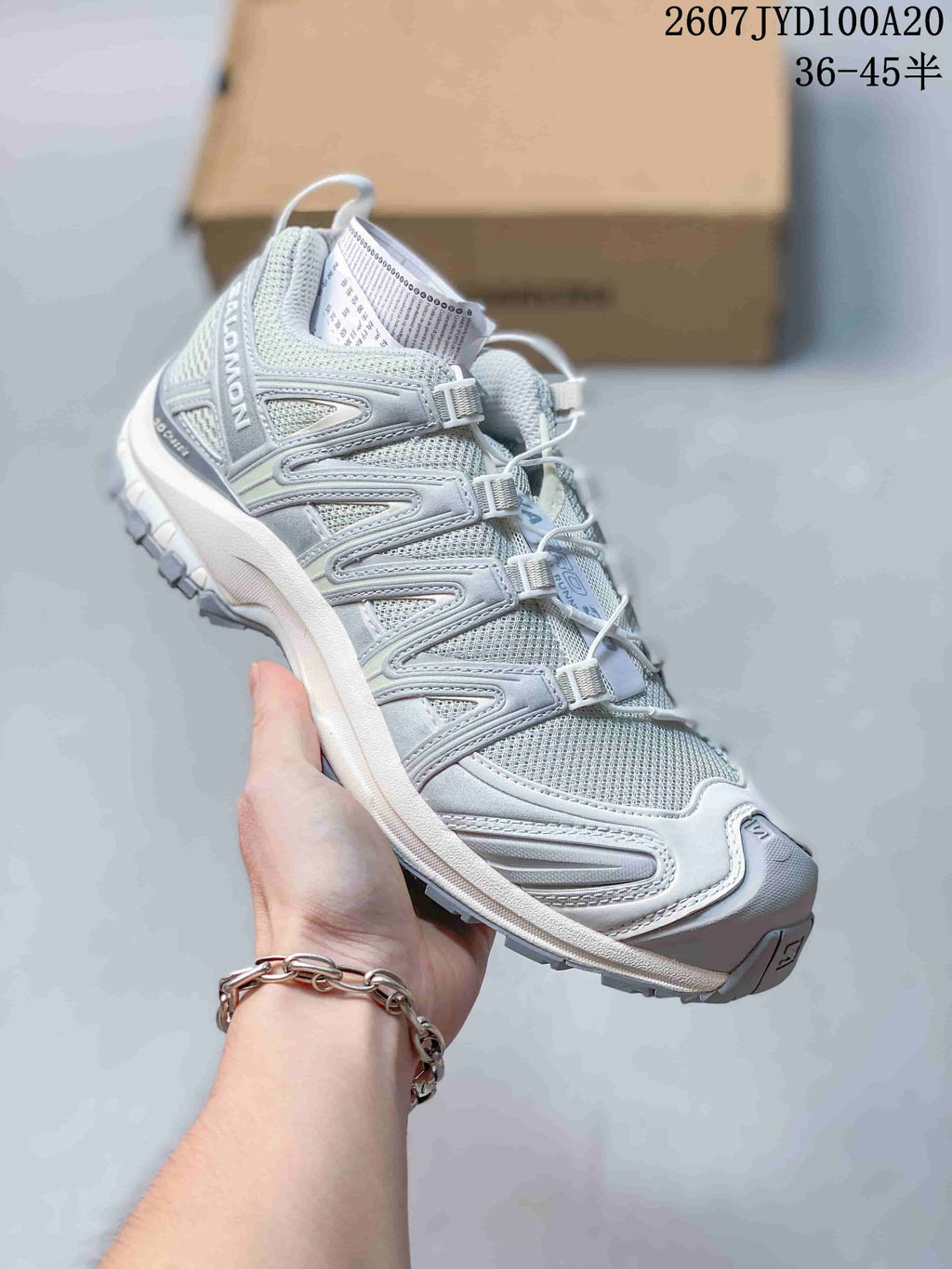 Light gray and white Salomon XA PRO 3D trail shoe showing the mesh upper and layered side overlays.