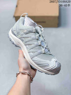 Light gray and white Salomon XA PRO 3D trail shoe showing the mesh upper and layered side overlays.