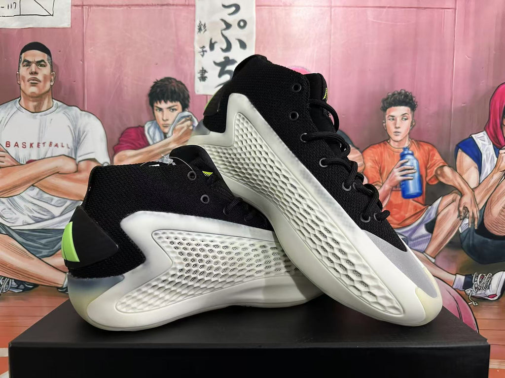 Two black basketball shoes shown together, highlighting the textured white panels and lime heel accents