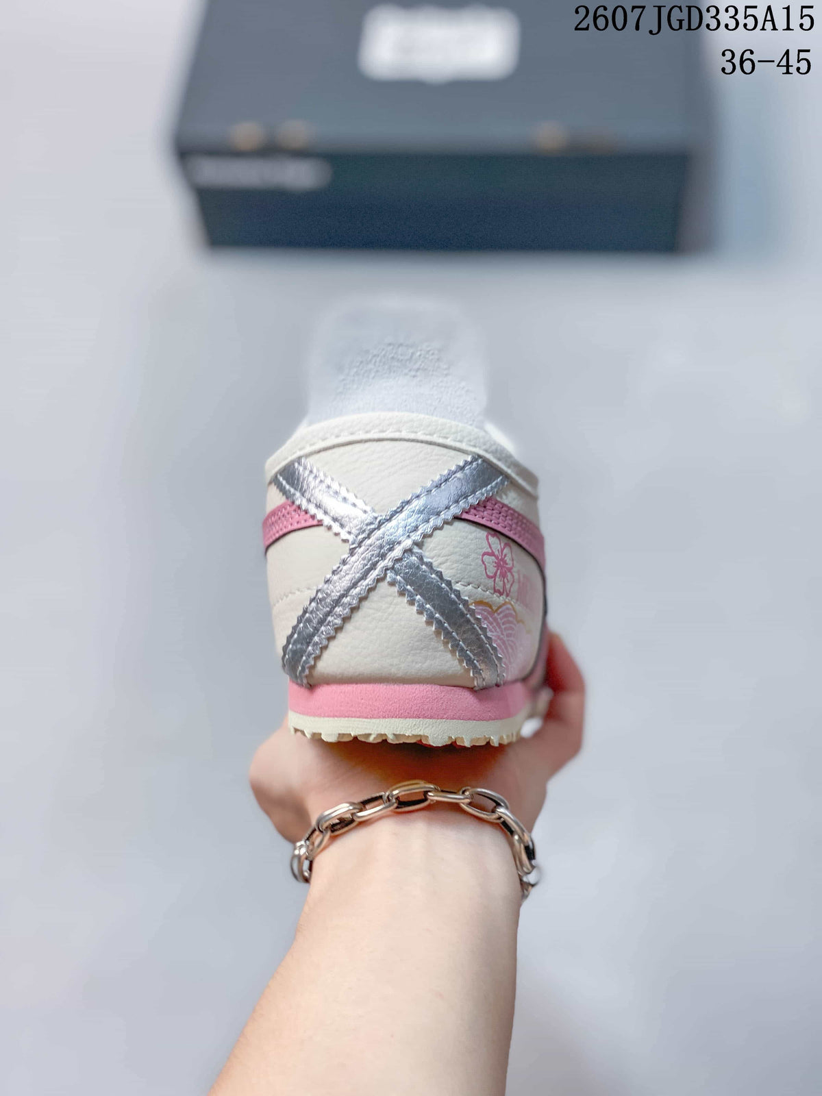 Rear view showing the pink and silver crossed heel accents and pink outsole detail.