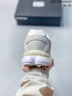 Rear view of the sneaker showing the padded heel collar, mesh heel panel, and rounded outsole design.