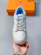 Top view showing the perforated toe box, patterned laces and light blue tongue details.