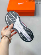 Outsole view showing black rubber traction sections and a white center panel.