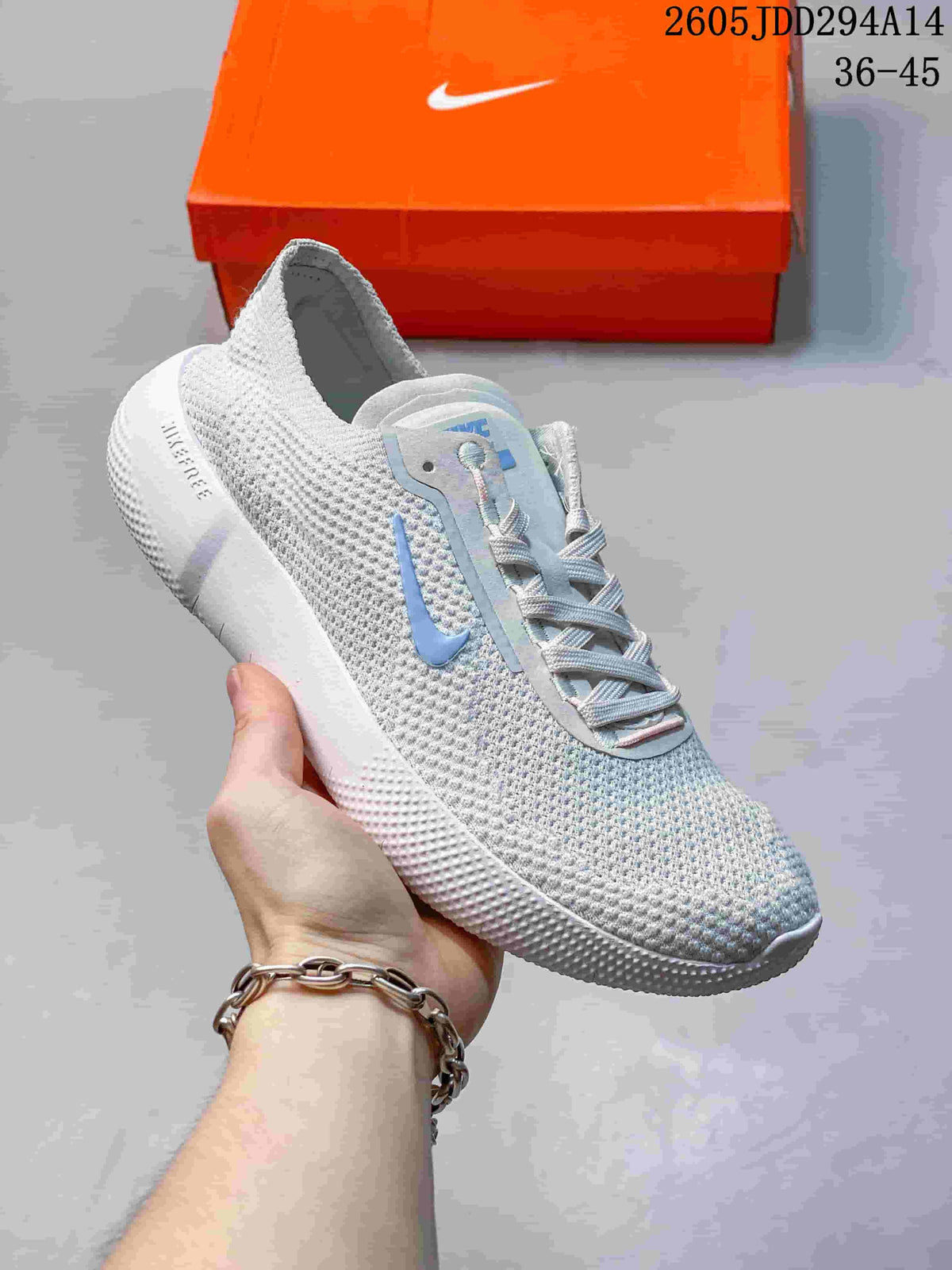 Angled side view of the light gray Nike Free sneaker showing the knit upper, blue Swoosh, padded collar, and white outsole.