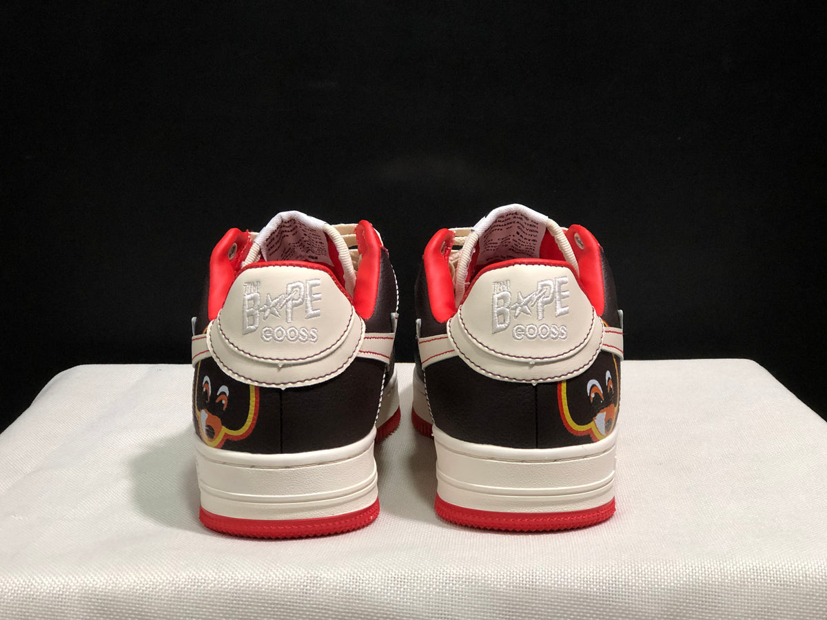 Rear view showing the branded heel panels, graphic heel detail, padded red collars, and red outsole edges.