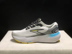 Side profile of one Brooks Glycerin 21 shoe, showing the white upper, grey heel panel, blue midsole accent, yellow outsole edge, and Brooks branding.