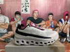 Side view of a grey-white sneaker with pink laces, black branding panel and sculpted sole.