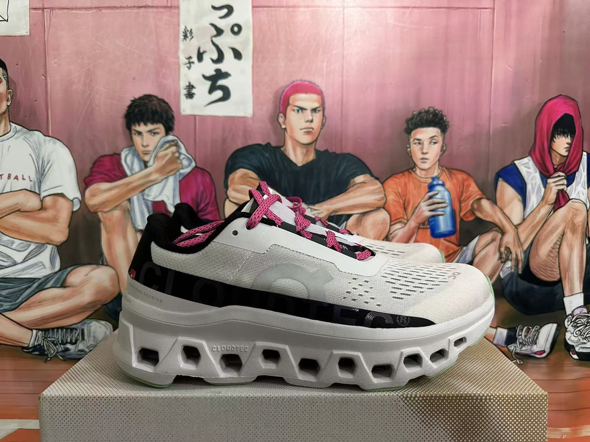 Side view of a grey-white sneaker with pink laces, black branding panel and sculpted sole.