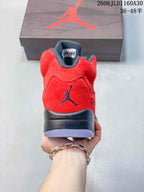 Rear view of the red sneaker with a dark heel logo and midsole.