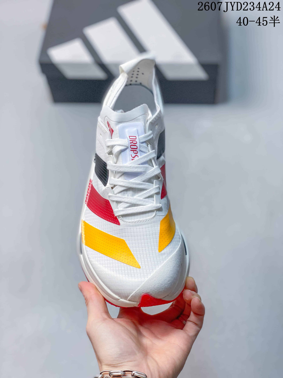 Top view of the white lace-up shoe with red and yellow forefoot accents.