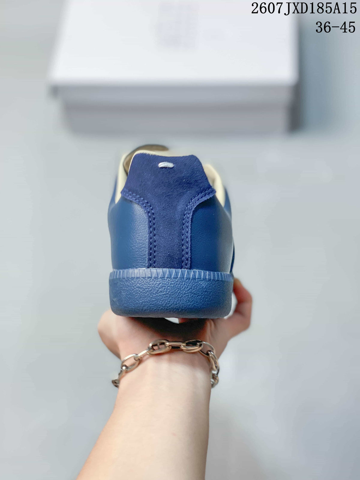 Rear view of the blue sneaker showing the tonal heel panel, cream collar lining, and blue rubber heel section.