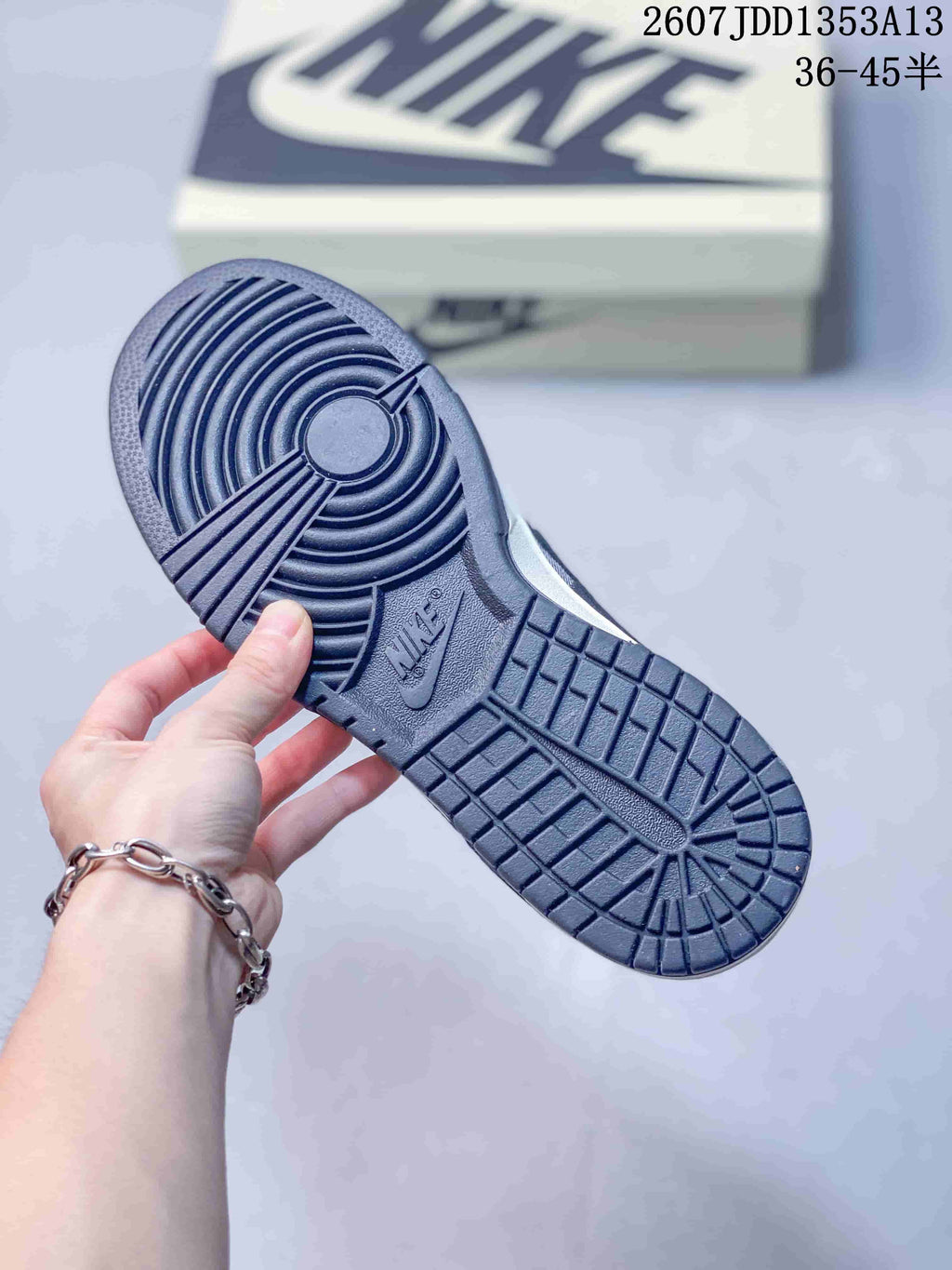 Underside view showing the navy rubber outsole traction pattern and Nike branding.