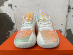 Front view of pastel-patterned Nike basketball shoes with white laces and yellow tongue details.