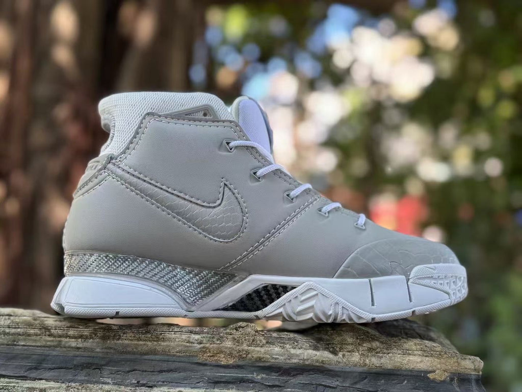 Side view of a grey and white Nike Kobe 1 FTB high-top shoe