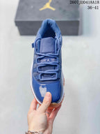 Top view of the blue sneaker showing the tongue, tonal laces, mesh panels, and glossy toe box.