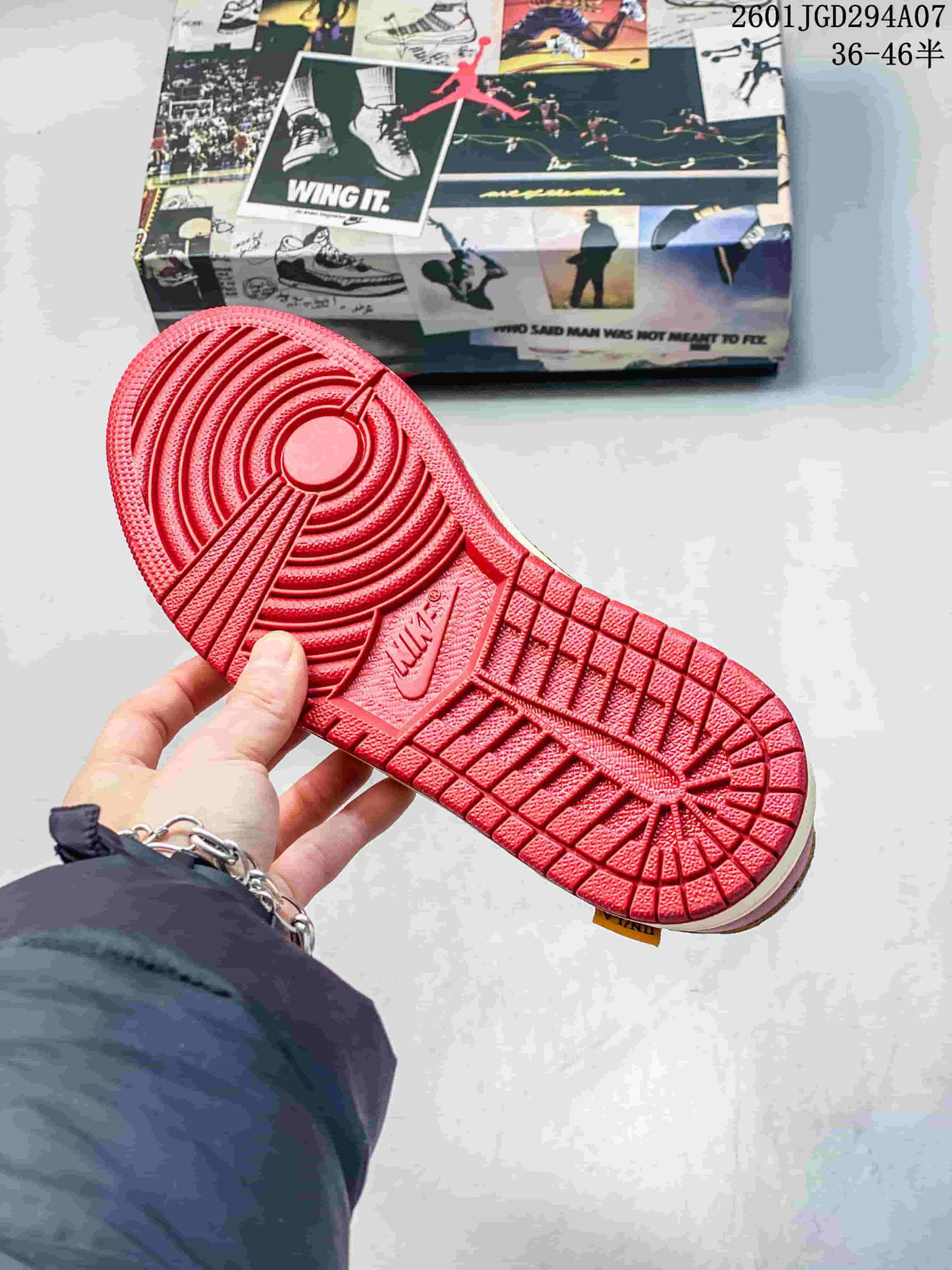 Red rubber outsole shown from below, with a circular traction pattern and molded logo details.