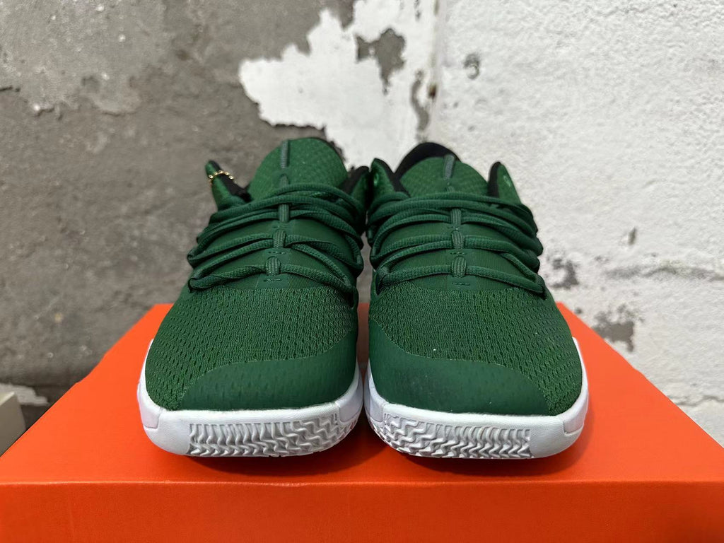 Front view of green Nike shoes with laces and white patterned outsoles