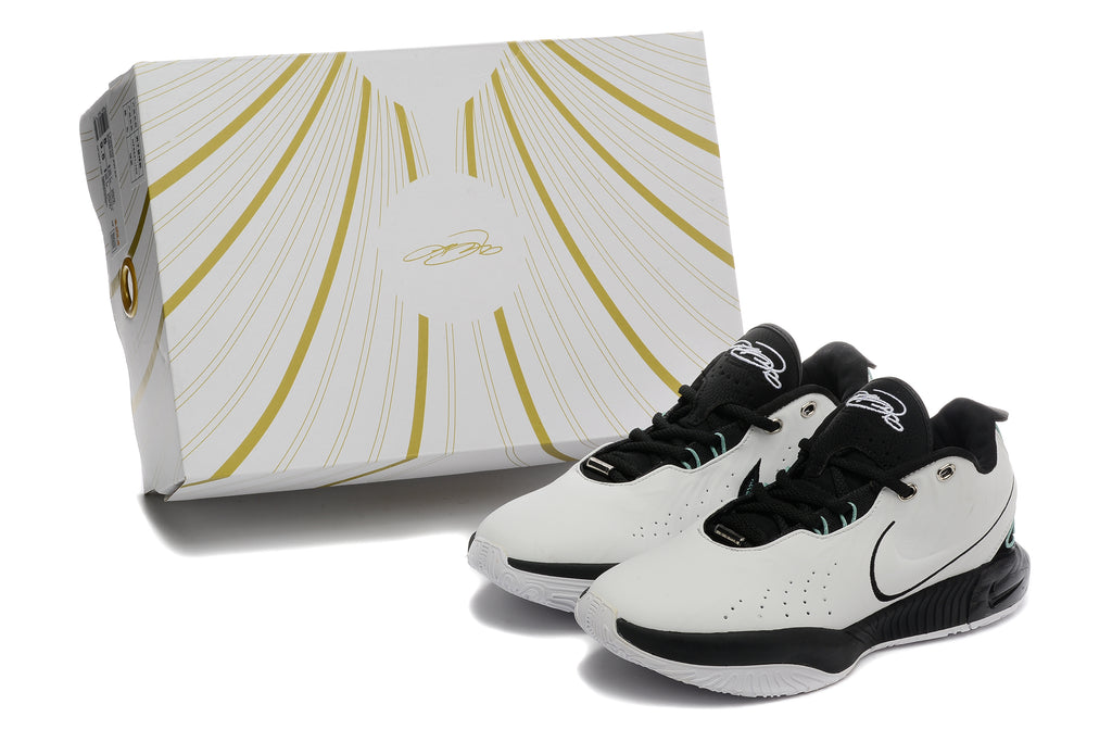 Pair of white and black Nike basketball sneakers beside a white-and-gold box