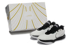 Pair of white and black Nike basketball sneakers beside a white-and-gold box