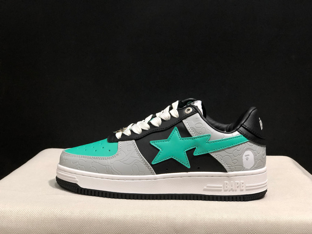 Side profile showing the turquoise star emblem, textured grey panels, black upper and white midsole.