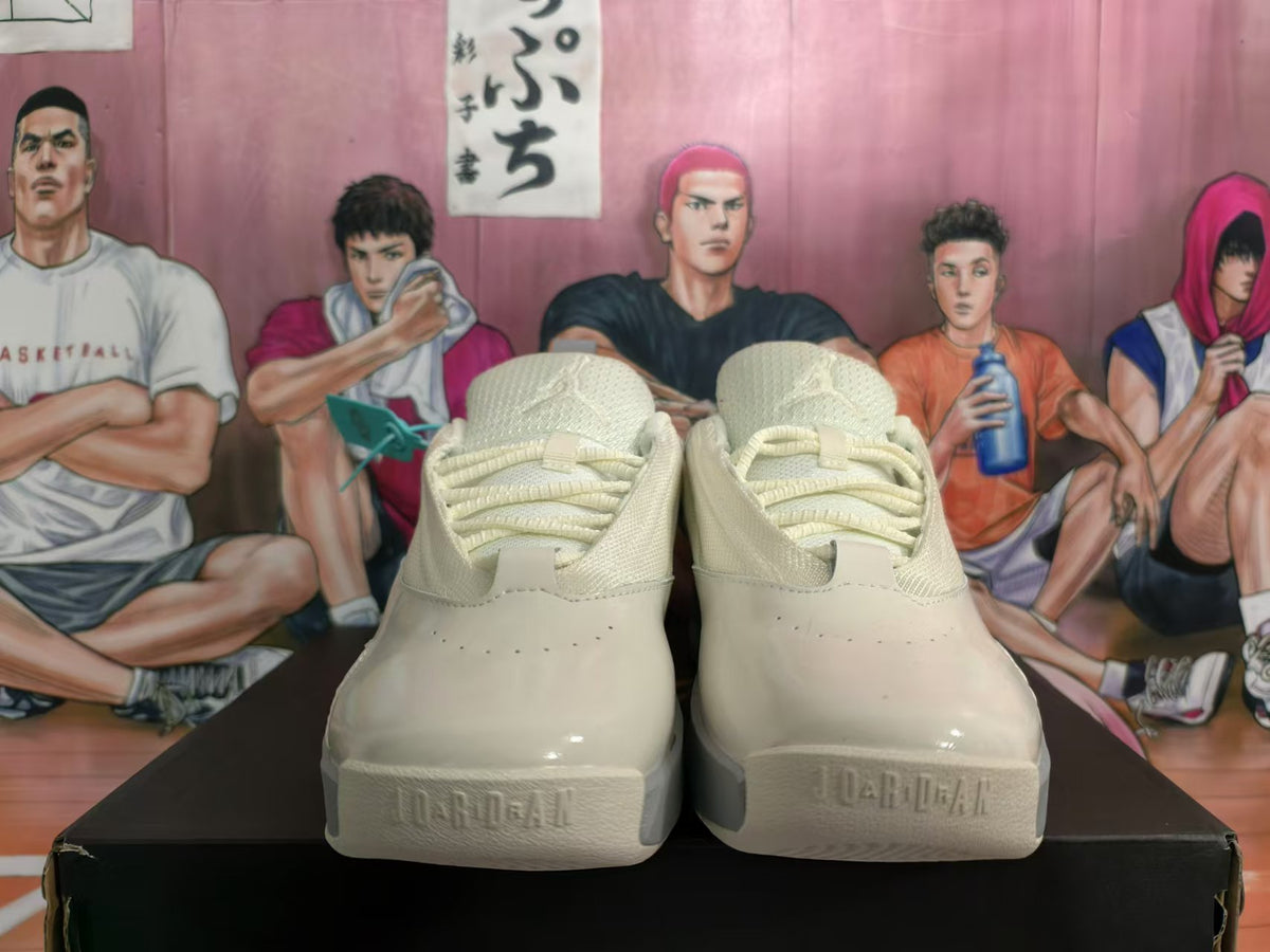 Front view of beige lace-up sneakers with rounded toe panels