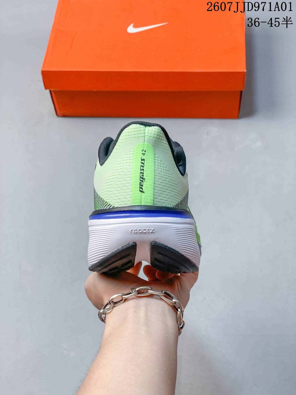 Rear view of a Nike Pegasus 42 shoe with a light green heel and white midsole