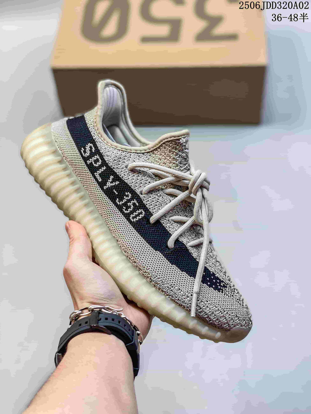 Light gray Adidas Yeezy-style sneaker with a dark side stripe and pale ridged sole.