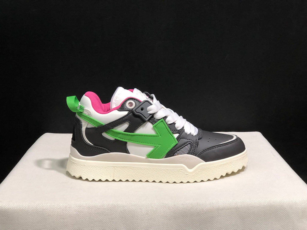 Opposite side profile showing the black and grey upper, green arrow detail, white laces and rear pull tab.