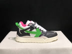 Opposite side profile showing the black and grey upper, green arrow detail, white laces and rear pull tab.