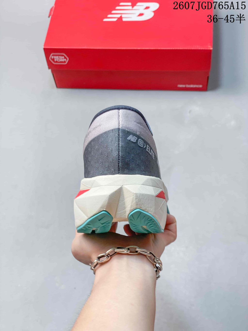 Rear view showing the gray heel, sculpted white midsole and turquoise outsole sections.