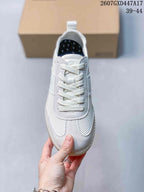 Top view showing the white lace-up construction, perforated forefoot panels and padded tongue.