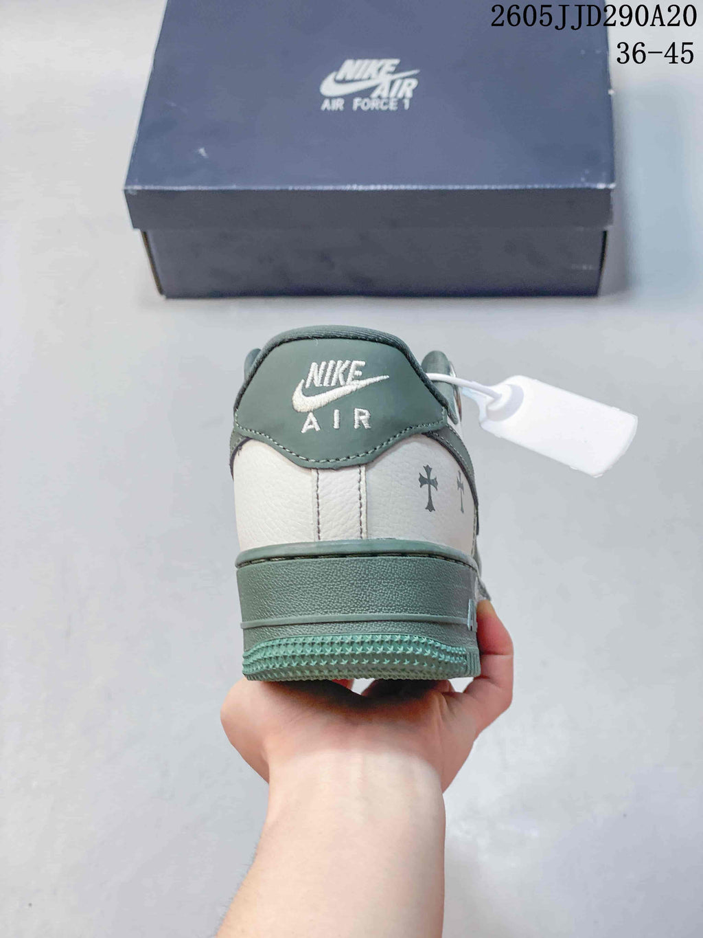 Rear view showing the green heel panel, white upper section, padded collar, and layered outsole.
