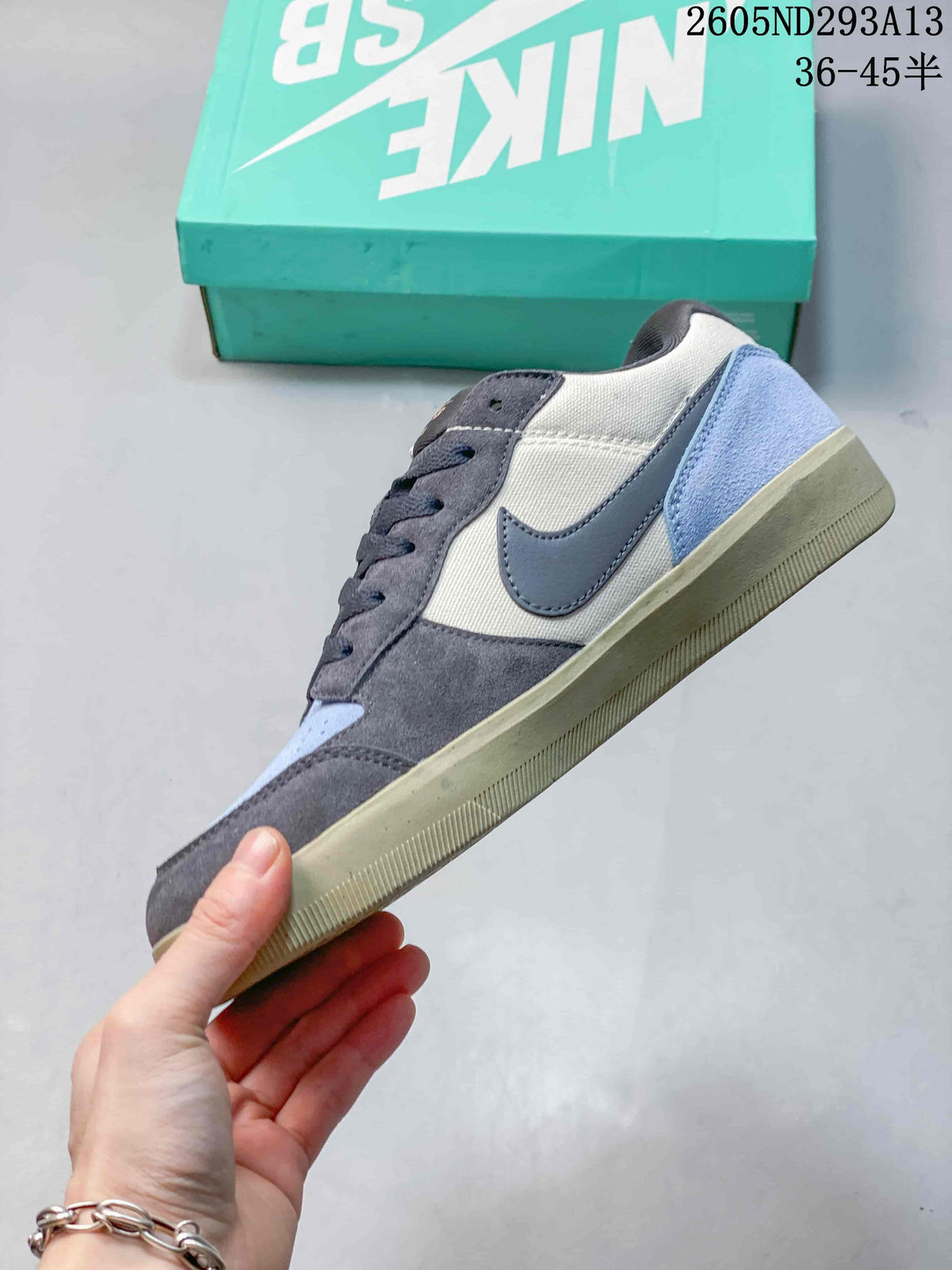 Side profile of the low-top sneaker showing the dark Swoosh, contrasting panels and textured rubber sole.