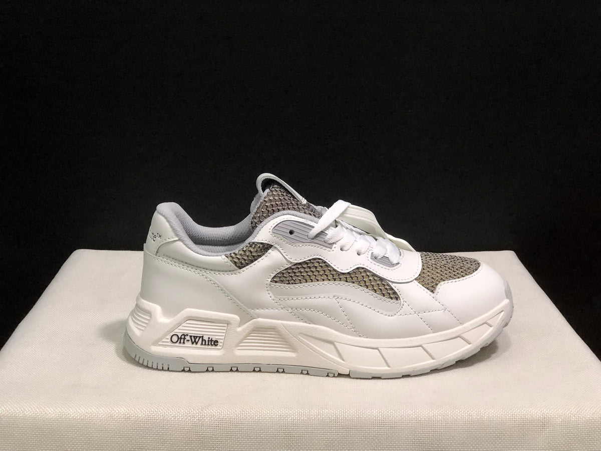 Side profile of a white and grey sneaker with visible Off-White branding on the midsole detail.