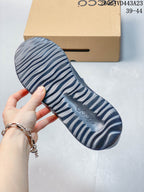 Underside of the sneaker showing a sculpted outsole with ridged tread