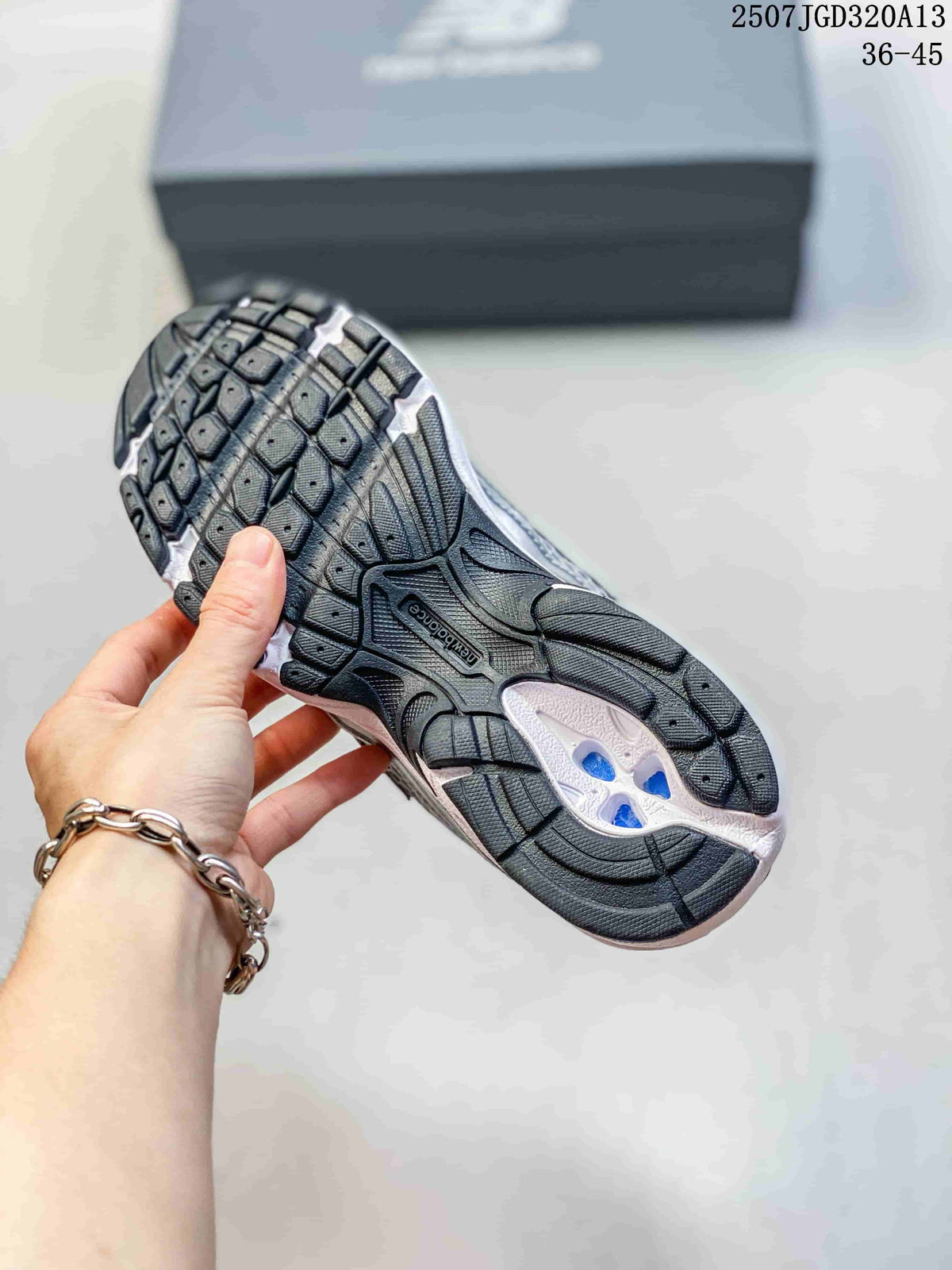 Close view of the black patterned rubber outsole and white midsole of a New Balance 740 sneaker.
