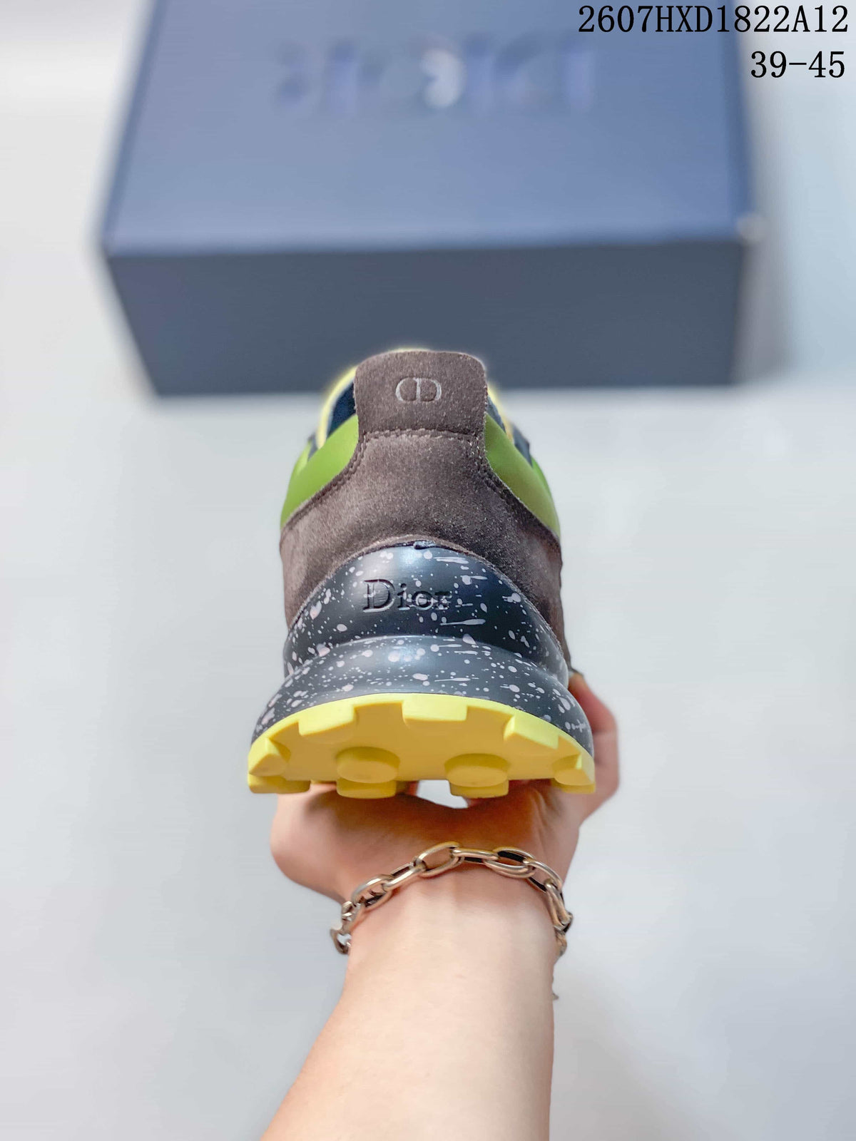 Rear view of the sneaker showing the brown heel panel, Dior branding, speckled midsole, and yellow outsole.
