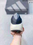 Rear view of the sneaker showing the dark textile-looking heel, padded collar and light-colored midsole.
